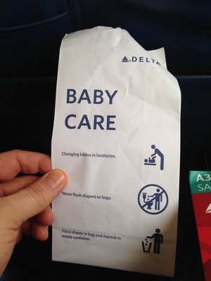 [A Delta airlines vomit bag with the label of “Baby Care”] Oh, so this is this years euphemism for this bag—okay then!