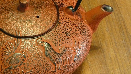 [Cast iron, baby!  I also like the rooster motif, as it matches early American folk art.]