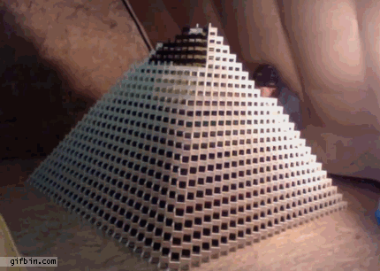 [Okay, it's a pyramid of dominoes that's collapsing and not a house of cards, but work with me people!  It's not that easy to find the right animated gif of a house of cards collapsing.]