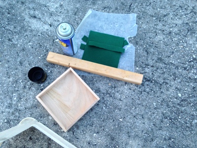[Wax paper to keep the felt off the asphalt, and a scrap piece of wood to keep the wax paper on the asphalt.]
