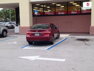 [This person managed to park perfectly in the handicapped walkway between two handicapped parking spots.  That takes real skill!]