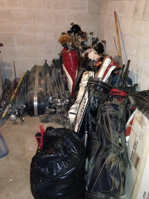 [There's at least a dozen golf bags full of golf clubs, plus piles of golf clubs.]
