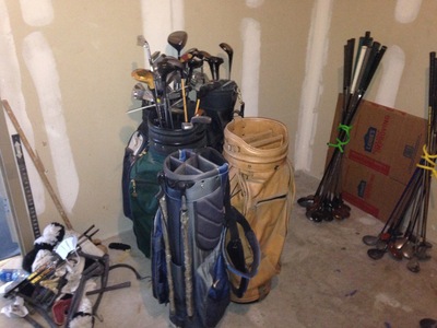 [Four golf club bags, plus a few loose drivers.  If only this was the extent of the problem.  If only … ]
