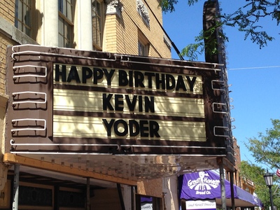 [A movie theater marquee with “HAPPY BIRTHDAY KEVIN YODER” displayed] Kevin Yoder?  Wasn't he that small green guy in “War Stars” or something?