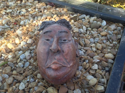 [The pottery bust of what looks like Kim Jong-un on a bed of rocks] “Wow dude! I'm stoned out of my head!”