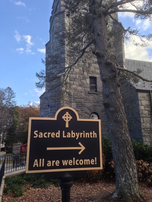[Picture of a sign that points to a “Sacred Labyrinth.” Behind the sign is a stone tower.] This way for the labyrinth.  Oh, the tower?  That's for our … unwelcomed guests.