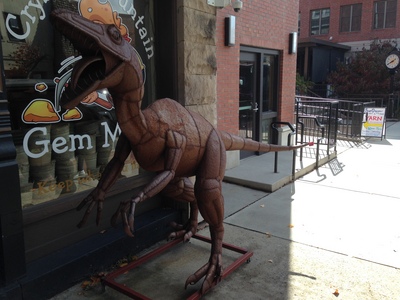 [A metal statue of a velociraptor in downtown Brevard, NC] He's just looking for a hug.