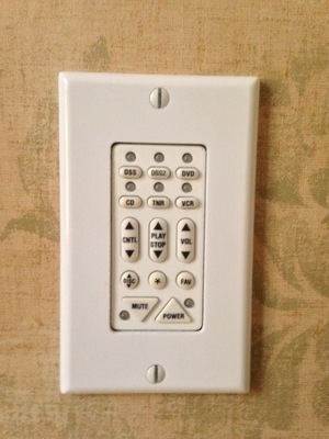 [A small conrol panel to what looks like a media center] If this is a remote, what is it doing embedded into the wall?